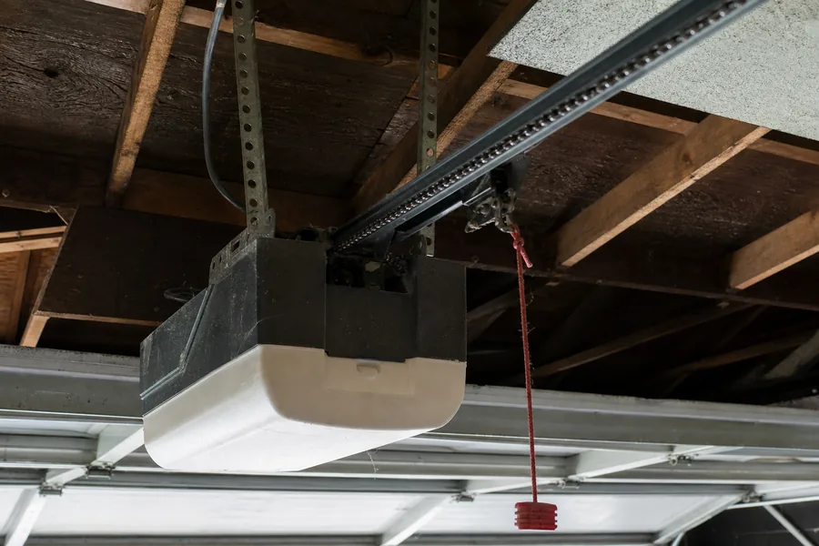 A garage door opener motor and rail in a Lewisville, TX garage