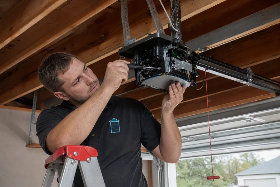 Fast Lane Garage Doors technician repairing a garage door opener in Lewisville, TX